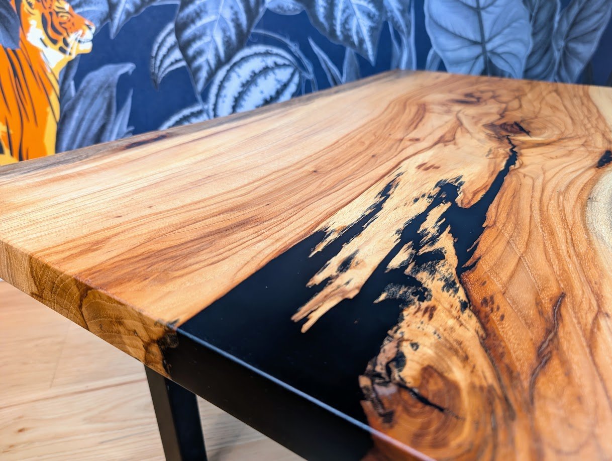 Pecan slab coffee table with black epoxy